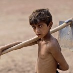 Imran Sheir, 10, at work in a brick factory on the outskirts of Islamabad, Pakistan (AP Photo/Muhammed Muheisen)