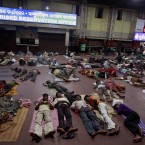 Passengers sleep on a platform at the railway station in Bhubaneswar, India (AP Photo/Biswaranjan Rout)