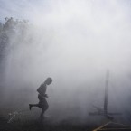 Children play in water outside a school in Milwaukee, Wisconsin. (AP Photo/Morry Gash)