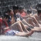 Children sit in a fountain during a baseball game in Chicago. (AP Photo/Charles Rex Arbogast)
