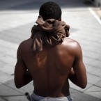 A walker strips off, in Philadelphia. (AP Photo/Matt Rourke)