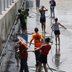 Kids play with hoses in Lebanon, Ohio. (AP Photo/Al Behrman)