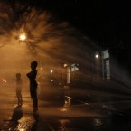 Standing under a fire hydrant in New York. (AP Photo/Mary Altaffer)