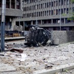 The wreckage of a car lies outside government buildings in the centre of Oslo on July 22, 2011, following an explosion that tore open several buildings including the prime minister's office. (AP Photo/Fartein Rudjord)