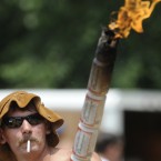 Preston Wright carrying the official Redneck Games torch smokes a cigarette at the 15th annual Redneck Games. Mike Stewart/AP/Press Association Images