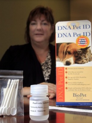 Debbie Violette, an apartment complex manager in New Hampshire, with a DNA test kit for pets. 