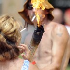 Preston Wright carrying the official Redneck Games torch lights the cigarette of Tabitha Wright. (AP Photo/Mike Stewart)