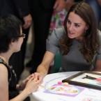 Kate talks to a young girl in a children's cancer ward as she visits Sainte-Justine University Hospital, in Montreal, Canada.