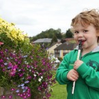 Two-and-a-half year-old Eoghan Gunn from Cavan attempts to play the tin whistle.