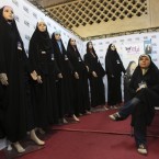Saleswoman Sedigheh Heidari waits for customers to buy her chadors at the Imam Khomeini grand mosque in Tehran, Iran (AP Photo/Vahid Salemi)