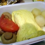 The tomato offers a fleck of colour to this Air Canada breakfast. <span class=