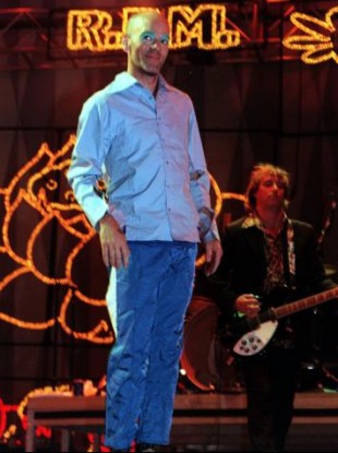 R.E.M. frontman Michael Stipe with Peter Buck in the background during the 1999 Glastonbury Festival. 