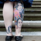 22 year old Beatles fan Linda Tomlinson shows off her tattoos as she waits for the wedding (Jeff Moore/Empics)