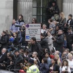 Fans and members of the media wait for the couple to emerge (AP Photo/Lefteris Pitarakis)