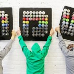 Curators lift a sign made from used spray cans. (Image: Niall Carson/PA Wire)