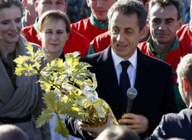 A proud Pappa: French President Nicolas Sarkozy receives an oak tree, as a gift after the birth of his daughter.