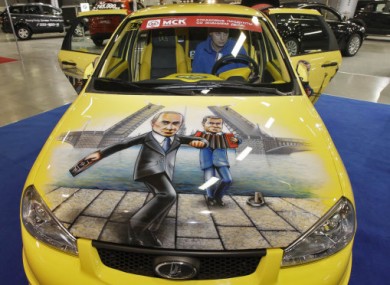 A Lada Kalina sports car with Putin and Medvedev painted on the bonnet appeared at an automotive exhibition last week. 