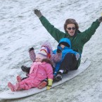 Tony Brennan with Lucy (5), Brian (3) and Erin (2) from Ballyfermot, slide down a hill on a surf board in the in the Phoenix Park.
Photo:Leon Farrell/Photocall Ireland