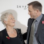 James Bond/Daniel Craig and Dame Judi Dench (who plays M) share a moment at the photocall for Skyfall. (AP Photo/Joel Ryan)