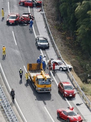 Damaged luxury cars are seen at the site of a traffic accident on the Chugoku Expressway in Shimonoseki, southwestern Japan