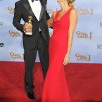 George Cloones poses backstage with the award for Best Actor in a Motion Picture Drama for the film The Descendants with Stacy Keibler. (AP Photo/Mark J. Terrill/PA Images)