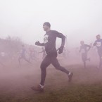 Competitors run through smoke. (AP Photo/Jon Super/PA Images)
