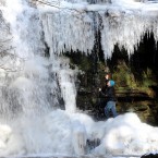 Walker Mark Proud looks at the mostly-frozen waterfall at Gibson's Cave at Bowlees, Middleton-in-Teesdale, England. Image: Owen Humphreys/PA Wire