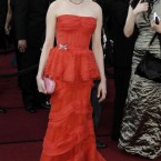 Michelle Williams wears Louis Vuitton. She wasn't even sure about its colour but thinks it may be coral. We're going with red-ish or orange-y. 

Image: AP Photo/Matt Sayles