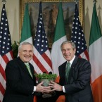 Together again: Bush accepts a given crystal bowl of shamrock from Bertie in 2007. (AP Photo/Pablo Martinez Monsivais/PA Images)