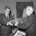 Ambassador Thomas Kiernan of Ireland presents a bowl of Irish shamrock to President John F Kennedy in 1961. Although you can't tell from this image, Kennedy wore a green tie for the occasion - one he borrowed from his appointments secretary Kenneth O'Donnell. (AP Photo/Harvey Georges/PA Images)