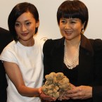 Angela Leong, right, wife of Macau tycoon Stanley Ho, holding the 1.5kg white truffle, celebrates with Mainland China's actress Zhou Xun after won the bid for US$330,000 during an auction in 2007. (AP Photo/Ho Chon In)