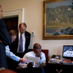 President Barack Obama seems more interested in the NCAA Men's Basketball Tournament game on the TV than the pretty picture on the wall in the Outer Oval Office. (Official White House Photo by Pete Souza)

