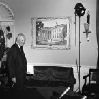 President Dwight D. Eisenhower enters his office in the White House in Washington in 1959. On the wall is an oil painting of the White House by artist Guy Wiggins. (AP Photo/Harvey Georges)
