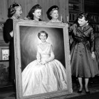 First lady Mamie Eisenhower looks at an oil painting of herself, a gift for her sixtieth birthday, in the White House Library in Washington in 1956. In the portrait, the first lady is wearing the pink gown worn at the inauguration ball. (AP Photo)