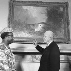 President Dwight Eisenhower points to an oil painting on the wall of his White House office in Washington in 1961. The art work is a Bavarian scene owned by Dr. Howard Snyder, Eisenhower's personal physician.(AP Photo/Bill Allen )