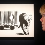 A Bonham's employee looks at Banksy's Leopard and Barcode, estimated to fetch an estimate of £60,000 - £80,000 at Urban Art. (Lewis Whyld/PA Images)