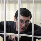 Former Ukrainian Interior Affair Minister Yuriy Lutsenko is seen in a detention cage in a courtroom, in Kiev, Ukraine in February 2012. Yuriy Lutsenko will stay in jail for two years and ten months since he has already been under arrest for one year and two months.(AP Photo/Sergei Chuzavkov)