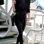 Victoria Beckham - who reportedly has a solid gold mobile phone- lands at Heathrow Airport. (Steve Parsons/PA Archive/Press Association Images)