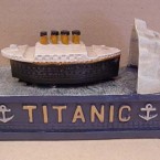 A coin placed on the Titanic mechanical bank 'sinks' into the bank after the ship crashes into the iceberg. Available for $37.99 from chandelierforum.com.