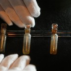 Vials of perfume oil raised from the wreck of the Titanic recovered from the wreck of the Titanic. (AP Photo/Alastair Grant)