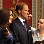 The new wax figures of the Duke and Duchess of Cambridge are given a final touch-up by make-up artist Rebecca Holmes, before they go on display at Madame Tussauds in London. (John Stillwell/AP Images)