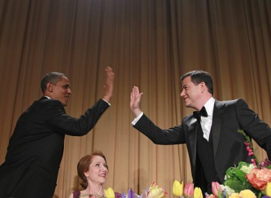President Barack Obama high-fives late-night comic Jimmy Kimmel as Caren Bohan, a Reuters journalist and president of the White House Correspondents' Association looks on