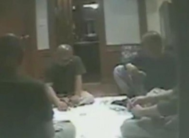Grainy footage shows the monks gambling and drinking 