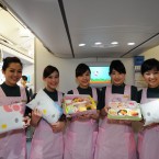 Flight attendants show the specially designed meals and bolsters on the Hello Kitty-themed aircraft. (Photo by ChinaFotoPress/PA)