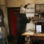 Barry Edgar Pilcher puts up a poster in his living room which was a polling station for the Fiscal Compact referendum on Inishfree Island, off Donegal. (Niall Carson/PA Wire)
