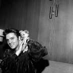 Elvis Presley plays with his puppy Sweet Pea on 18 October 1956. The evening before he had gotten into a fistfight with two filling station attendants, one of whom received a black eye. Presley said one of the men slapped him as he was signing autographs. (AP Photo/Gene Herrick/Press Association Images)