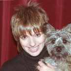 Liza Minnelli poses with her dog Lilly in her dressing room at the Opera House ahead of a benefit concert in Paris, France in 1989. (AP Photo/Lionel Cironneau/Press Association Images)