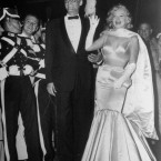 Actress Marilyn Monroe, escorted by her husband, playwright Arthur Miller, wears a big smile and waves to the crowd on arrival at the Radio City Music Hall in New York City, June 13, 1957. (AP Photo/Matty Zimmerman)
