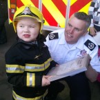 Dylan being awarded his plaque by Naas firemen.