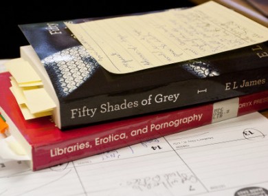 One US librarian, whose desk is pictured here, recommended that her library system did not stock the book as she deemed it primarily erotica. 